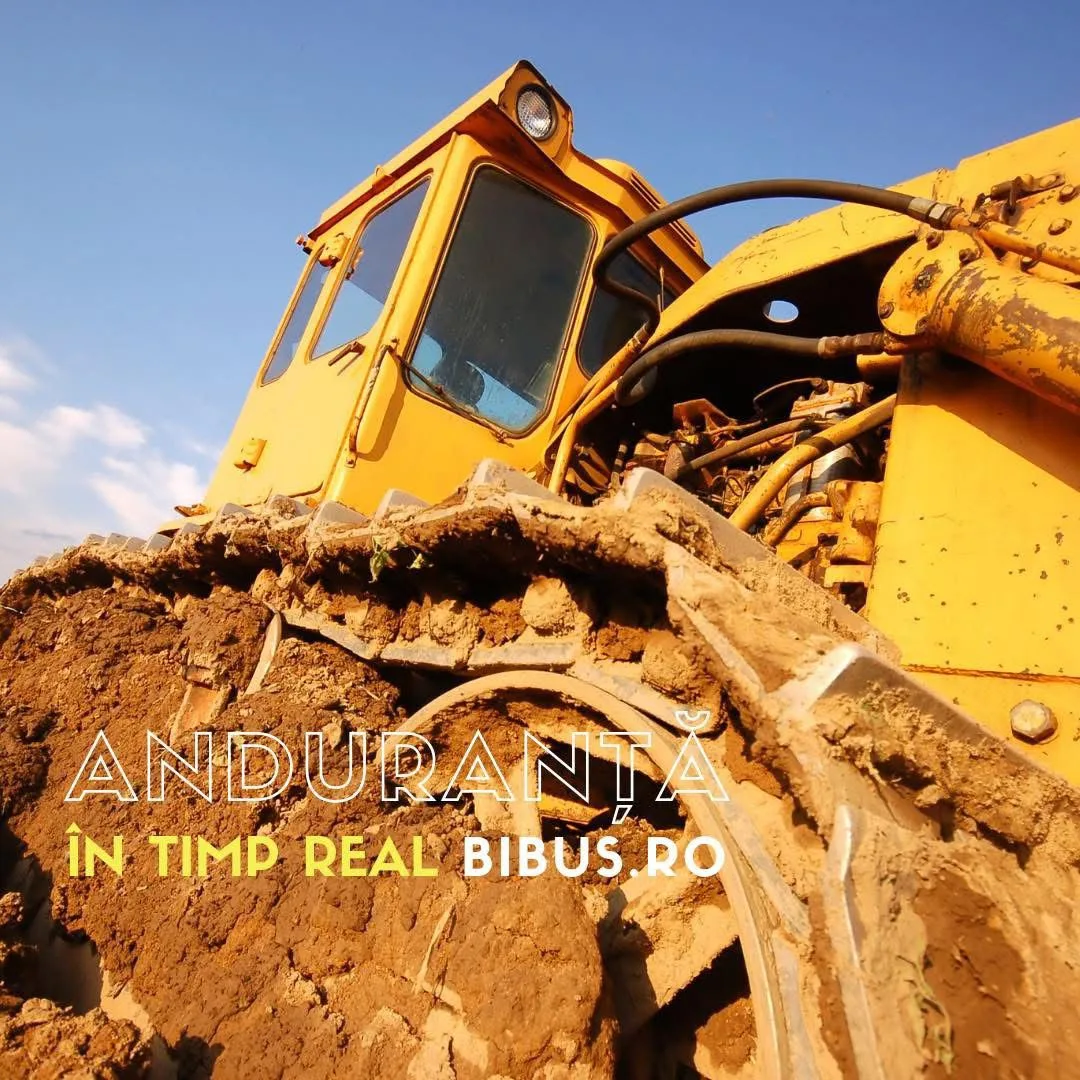A yellow bulldozer seen from a low angle, with the text “Anduranță în timp real · BIBUS.RO”